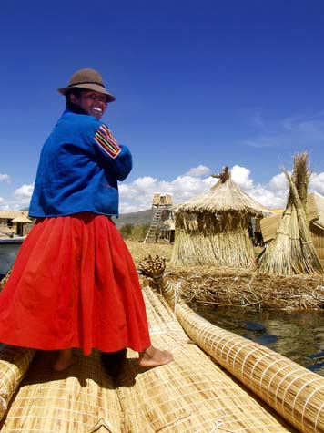 Uros woman paddling reed boat