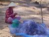 Khmer woman making a fishing net