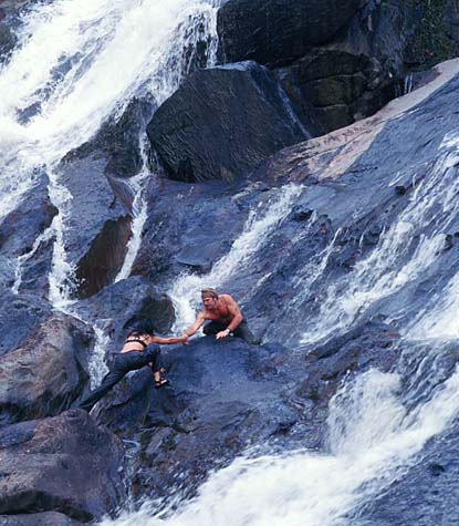 Photograph of a Marco and Maria climbing a waterfall