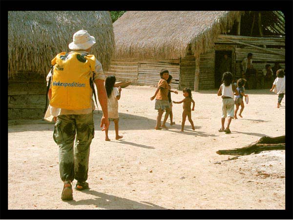 Kids leading Marco into Traditional Settlement