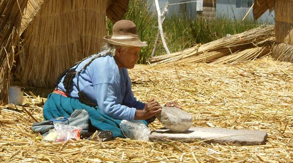 Uros woman grinding grain