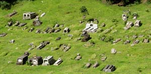 Graveyard near Lucma with graves of both raised fitted rock and cement styles